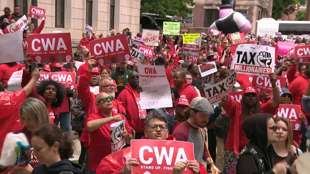 Public unions march on State House, call for millionaire’s tax