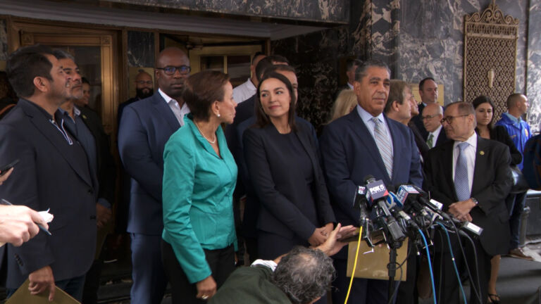 Congressional Democrats tour migrant hotel amid anti-immigrant protest
