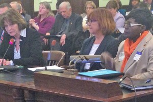 From left, Ann Twomey of the Health Professionals and Allied Employees union, Mary MacDonald of the American Federation of Teachers’ Healthcare Division, and Elfrieda Johnson of the JNESO nurses union testify about a proposal to increase mandatory nurse-staffing levels at hospitals.