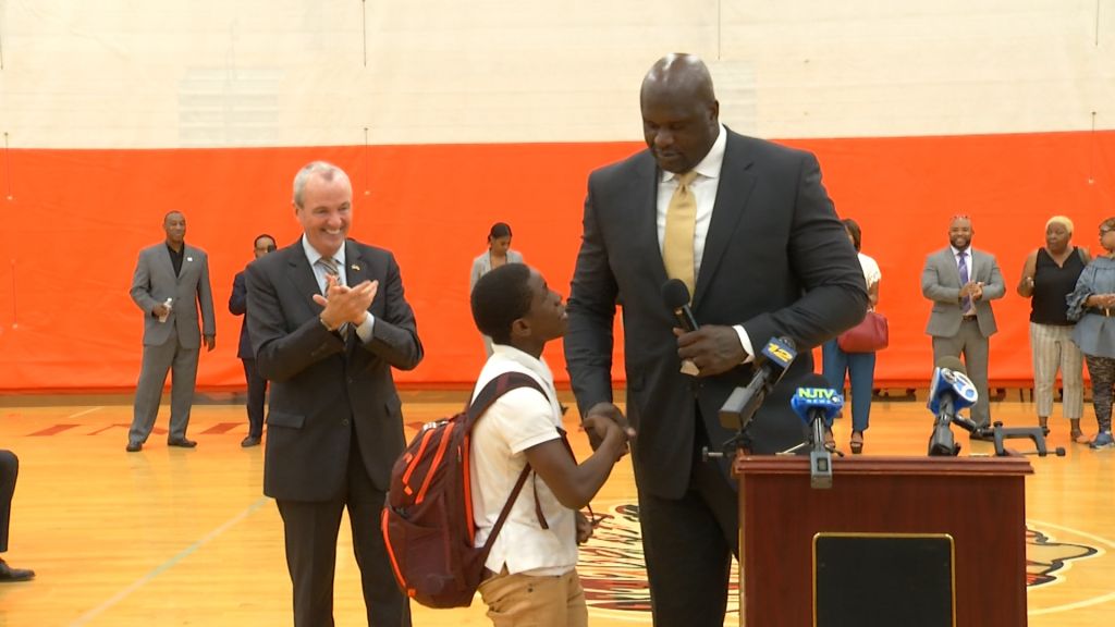 A Newark student shakes hands with Shaquille O'Neal